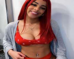 She has piercings on her belly button. Also has piercing on both sides of her nose and nose septum as well as her ears.